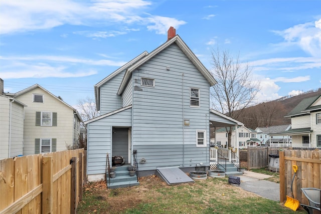 rear view of property with a yard