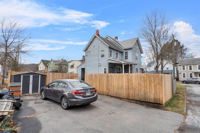 view of front of house with a storage shed