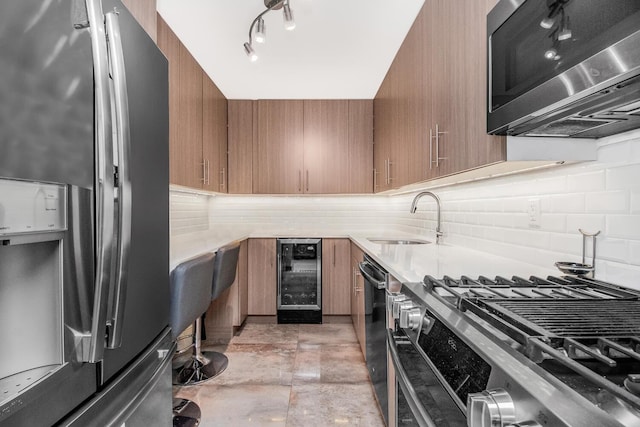 kitchen featuring backsplash, stainless steel appliances, wine cooler, and sink