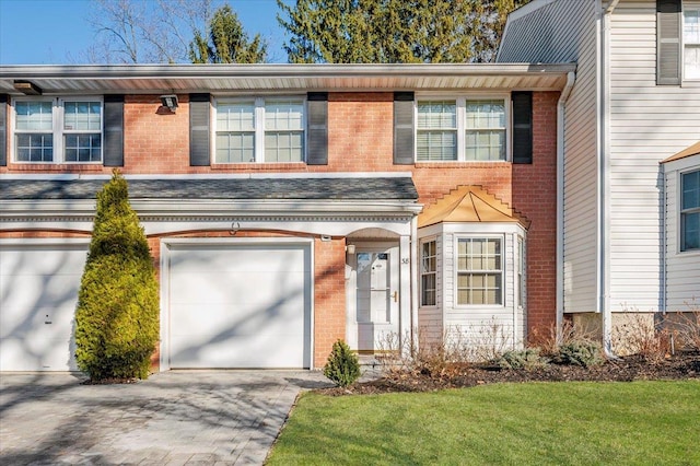 view of property with a front lawn and a garage