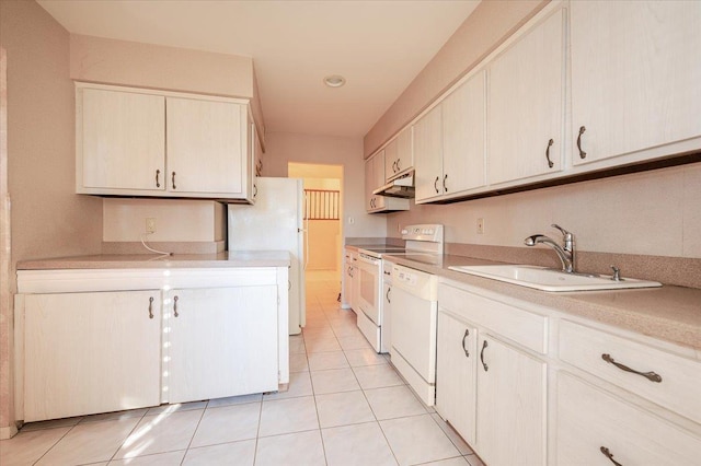 kitchen with sink, white appliances, and light tile patterned floors