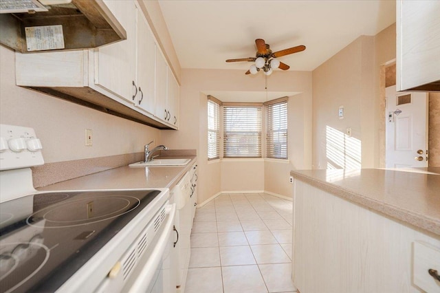 kitchen featuring white cabinetry, ceiling fan, light tile patterned floors, extractor fan, and electric range