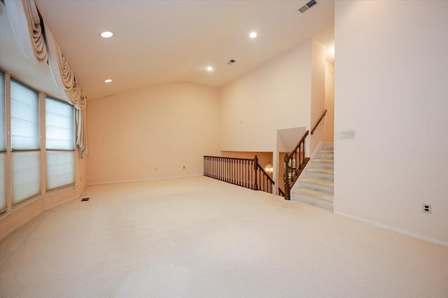 empty room featuring carpet flooring and vaulted ceiling