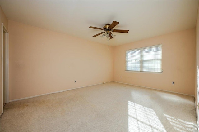 unfurnished room featuring ceiling fan and light carpet