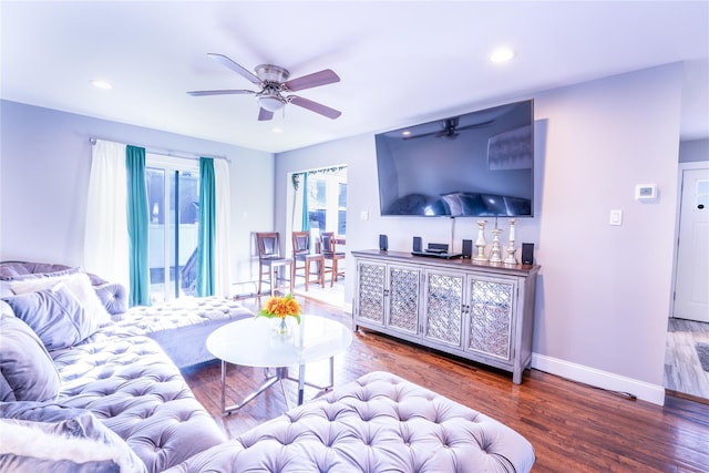 living room featuring hardwood / wood-style floors and ceiling fan