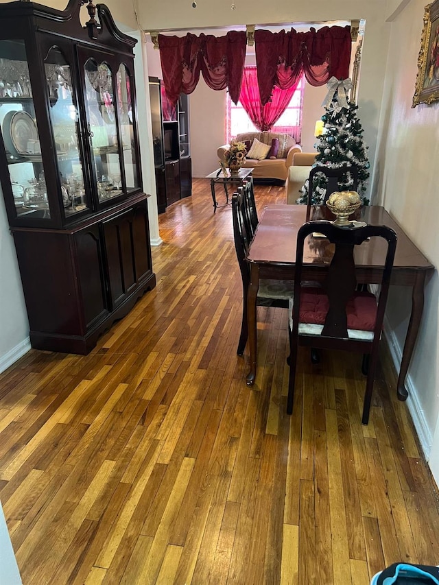 dining space with hardwood / wood-style floors