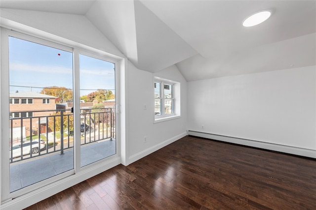 bonus room featuring vaulted ceiling, dark hardwood / wood-style flooring, a wealth of natural light, and a baseboard heating unit