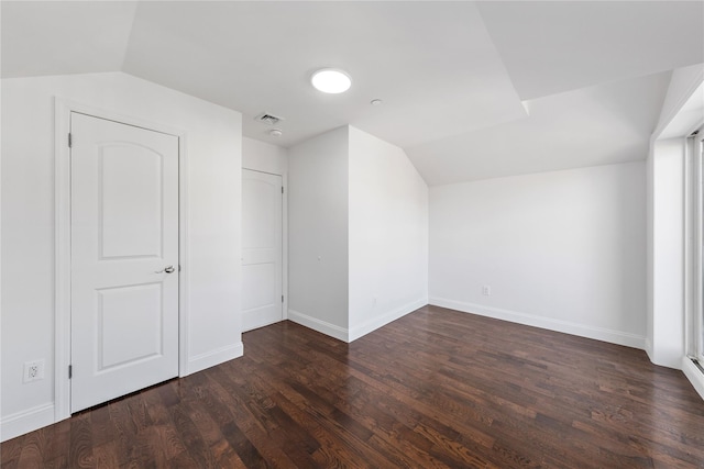 bonus room with dark hardwood / wood-style floors and vaulted ceiling