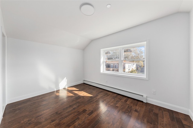 additional living space with dark hardwood / wood-style flooring, vaulted ceiling, and a baseboard heating unit