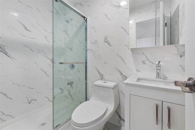 bathroom featuring a shower with door, vanity, tile walls, and toilet