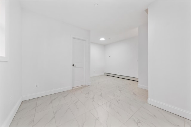 unfurnished room featuring baseboard heating