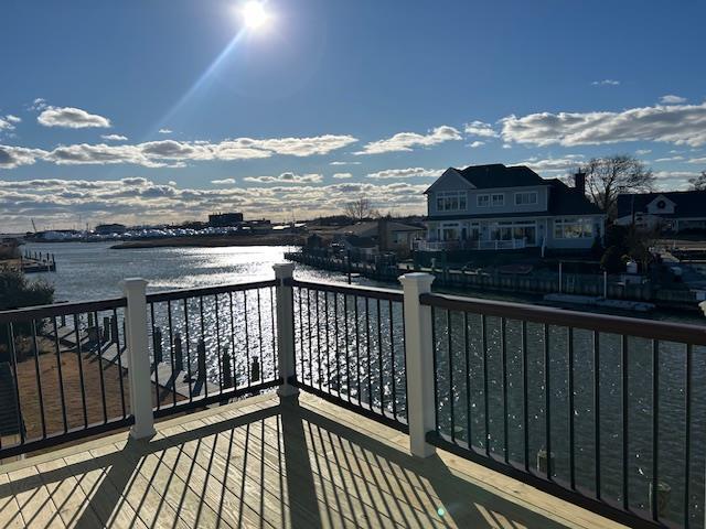 view of dock featuring a balcony and a water view