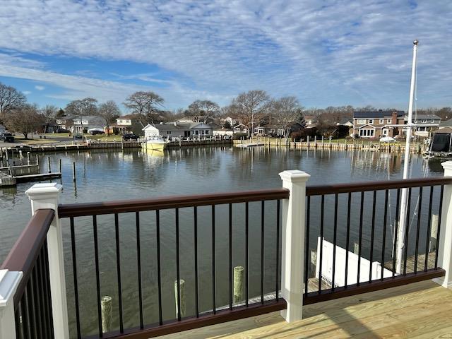 view of dock with a water view and a balcony