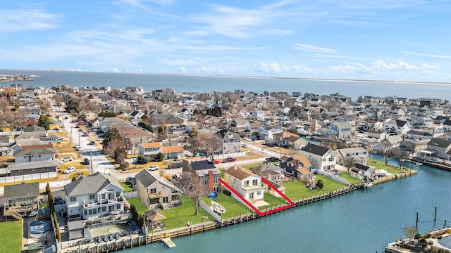 drone / aerial view featuring a water view and a residential view