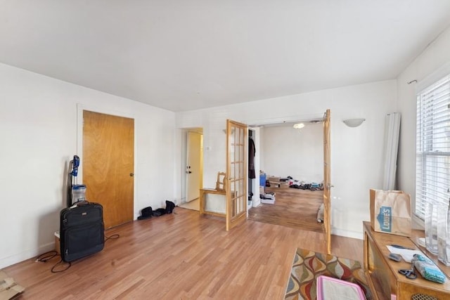 interior space with french doors and light hardwood / wood-style flooring