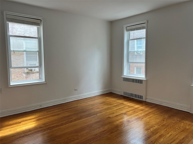 spare room with light hardwood / wood-style floors and radiator