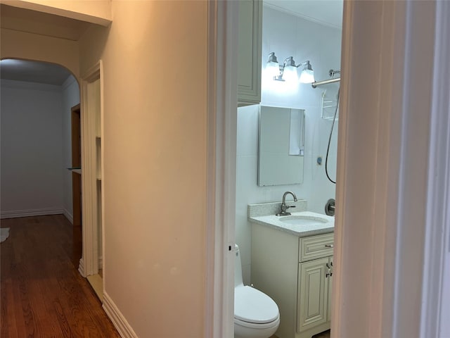 bathroom featuring hardwood / wood-style flooring, vanity, and toilet