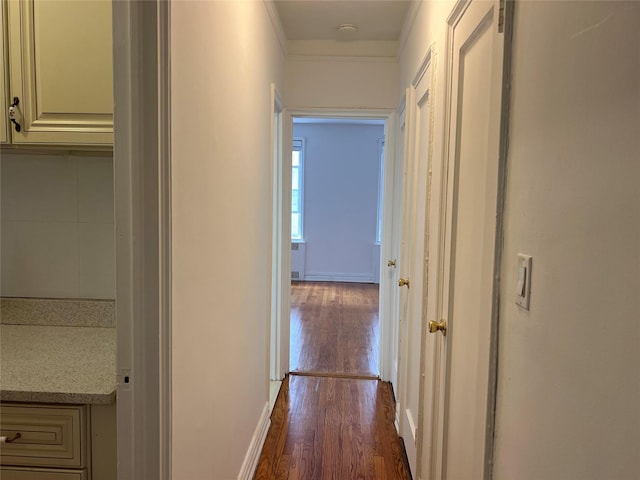 corridor featuring dark hardwood / wood-style floors and ornamental molding