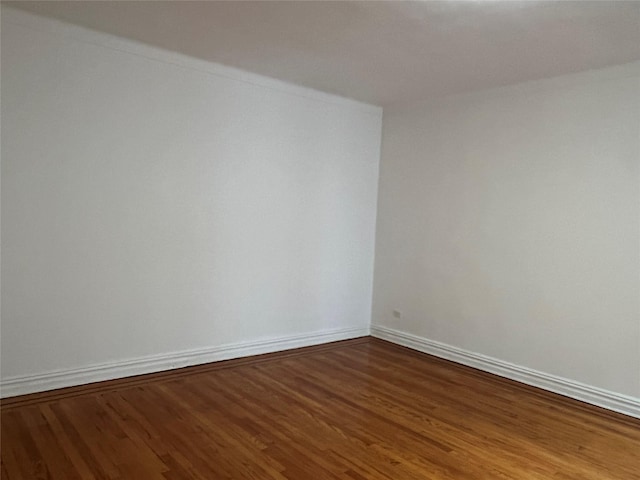 empty room with hardwood / wood-style flooring