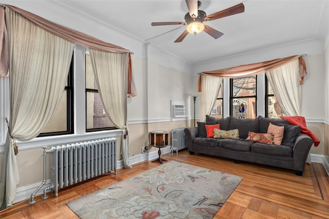 living room featuring radiator, ceiling fan, and light parquet flooring