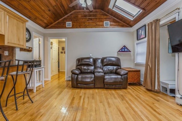 living room with crown molding, wood ceiling, and vaulted ceiling with skylight