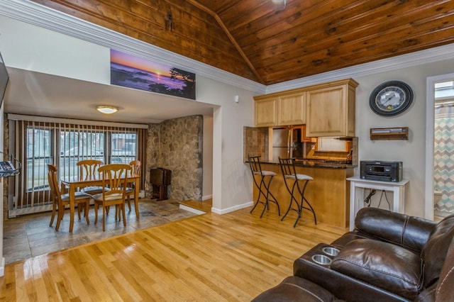 living room featuring ornamental molding, light hardwood / wood-style floors, vaulted ceiling, and wooden ceiling