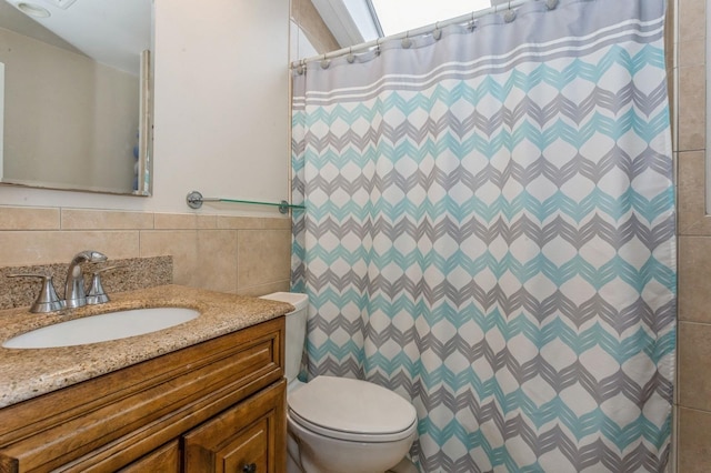 bathroom with vanity, toilet, tile walls, and a shower with curtain