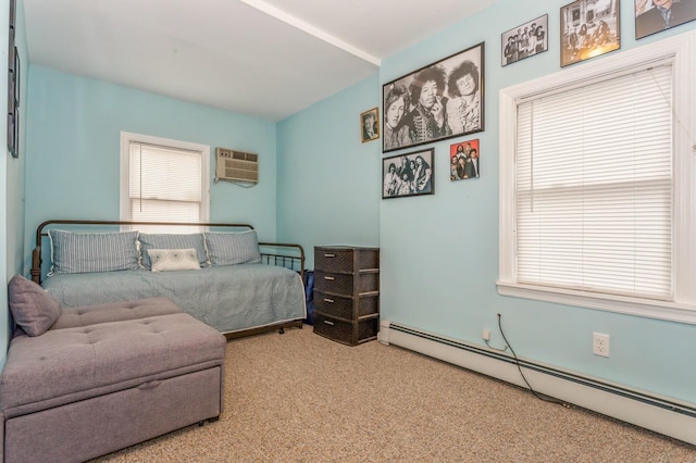 bedroom featuring an AC wall unit, light carpet, and a baseboard heating unit