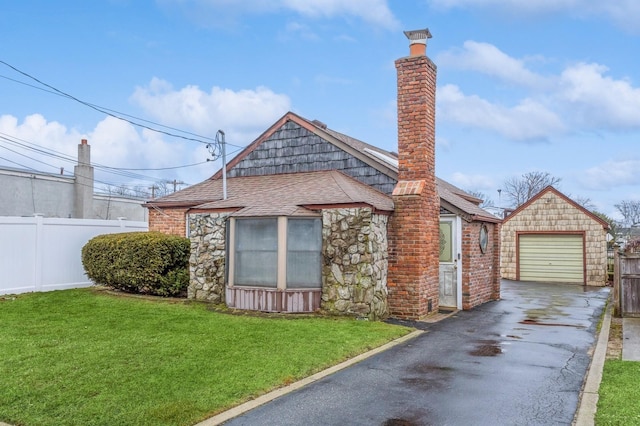 view of front of property featuring a garage and a front lawn