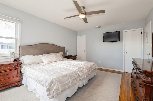 bedroom with ceiling fan and light hardwood / wood-style flooring