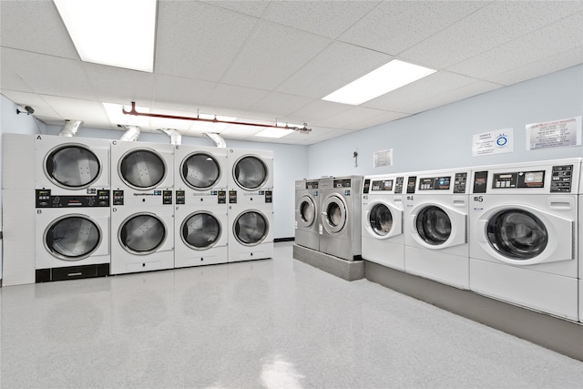 clothes washing area with stacked washer and dryer and washer and clothes dryer