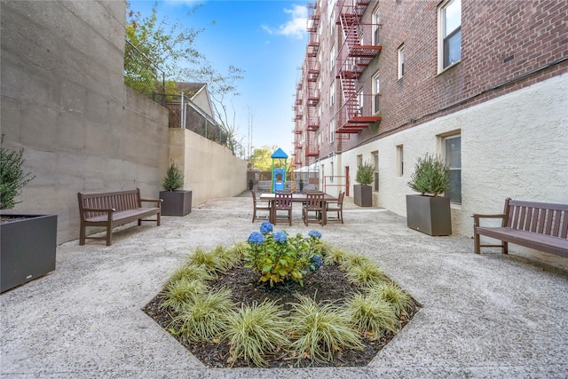 view of community featuring a patio and a playground