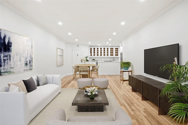 living room with crown molding and light hardwood / wood-style floors