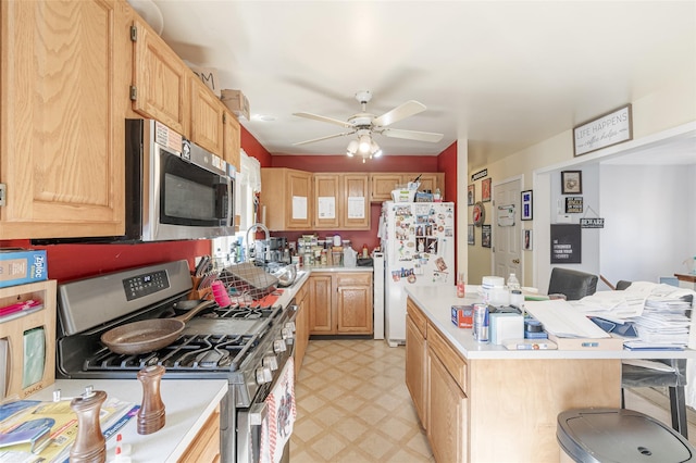 kitchen with a kitchen breakfast bar, a kitchen island, stainless steel appliances, light countertops, and light floors