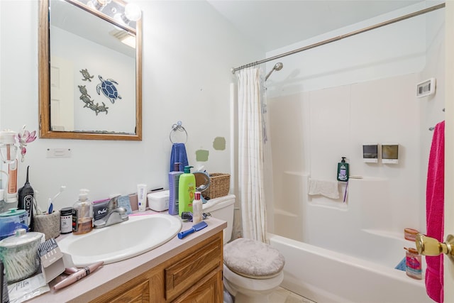 bathroom featuring toilet, vanity, and shower / tub combo