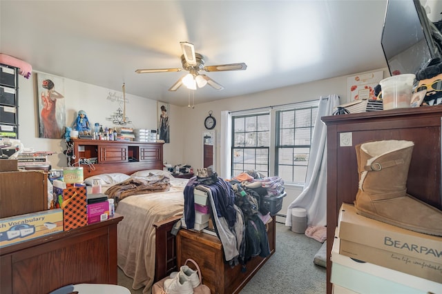 carpeted bedroom featuring a baseboard heating unit and a ceiling fan