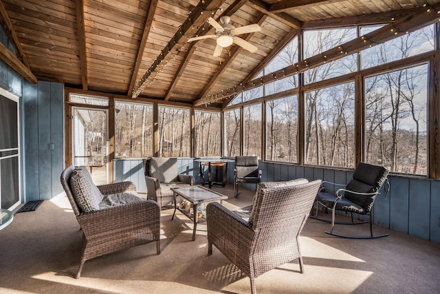 sunroom / solarium featuring vaulted ceiling with beams, wood ceiling, a wealth of natural light, and ceiling fan