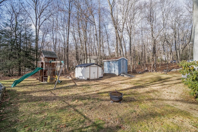 view of yard featuring a playground and a shed