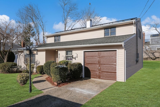 view of front of home with a front yard and a garage