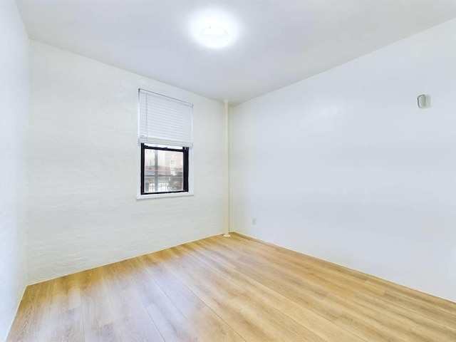 empty room with light hardwood / wood-style flooring