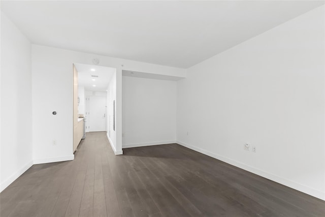 spare room with dark wood-type flooring