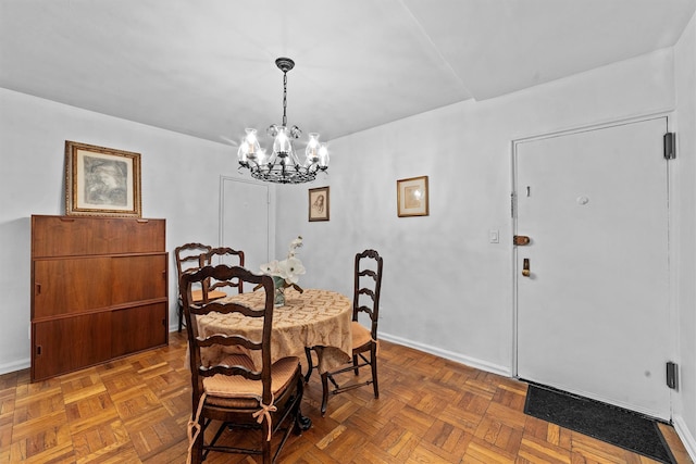 dining area with baseboards and a chandelier