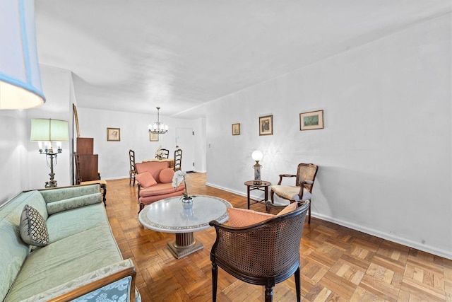 living room featuring baseboards and a chandelier