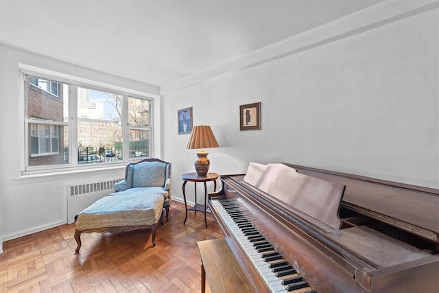 living area featuring baseboards and radiator heating unit