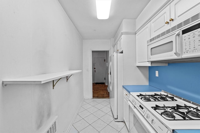 kitchen with light countertops, white appliances, white cabinets, and visible vents