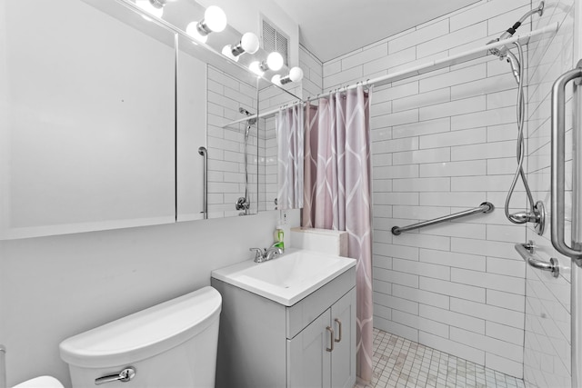 full bathroom with a stall shower, vanity, and toilet