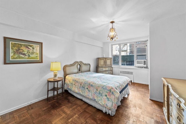 bedroom with radiator, a notable chandelier, and baseboards