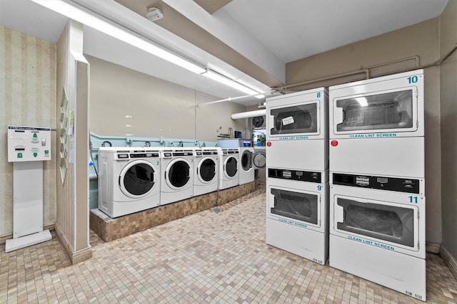 shared laundry area featuring washer and dryer and stacked washer / drying machine