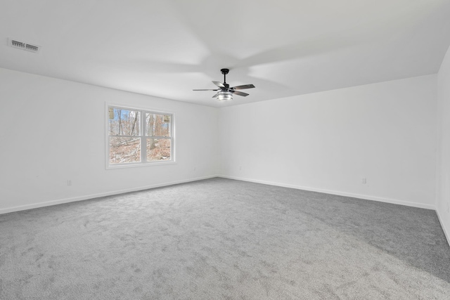 carpeted empty room featuring ceiling fan