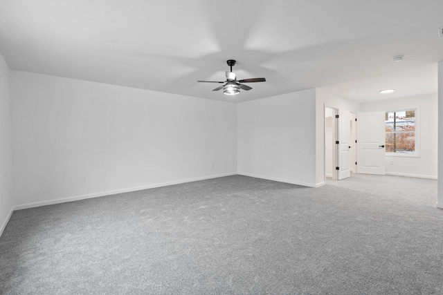 carpeted spare room with ceiling fan